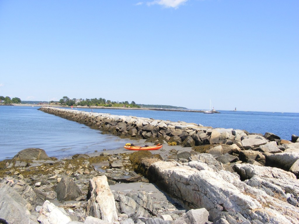 stone jetty separating harbor from ocean