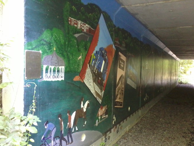 Local students painted the walls of the trail's underpass at Rt. 225 with scenes of area history.
