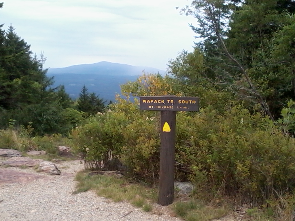 trail sign for Wapack Trail, and a view of mountain in the distance