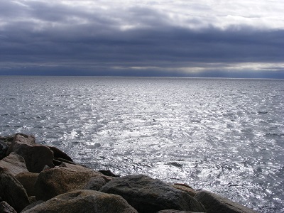 rocky shoreline, choppy ocean, low grey clouds