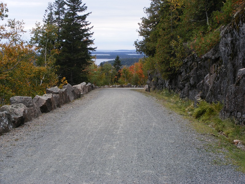 wide unpaved trail lined with large stones