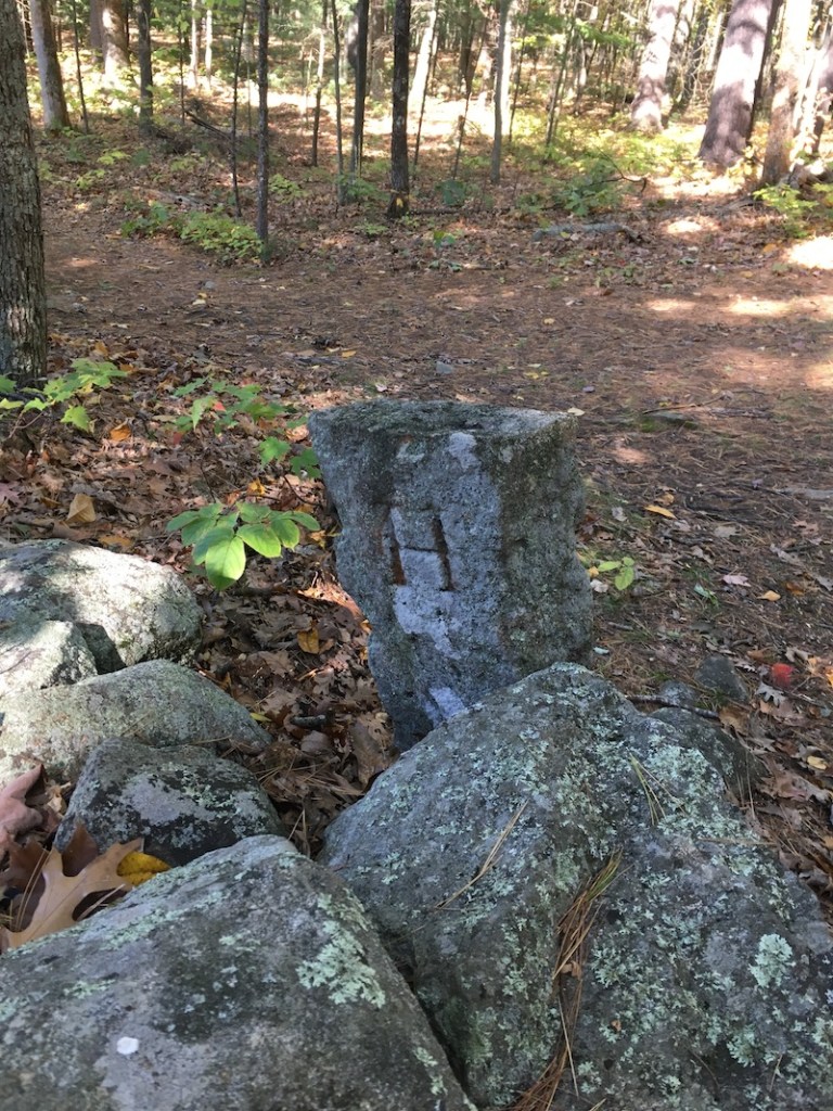 granite marker etched with letter "H"