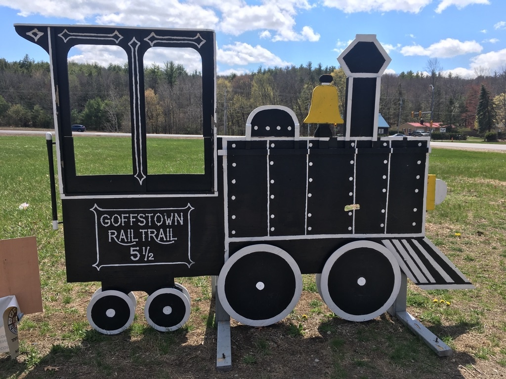 Decorated wooden cutout of an old-fashioned train engine on the Goffstown (NH) Rail Trail
